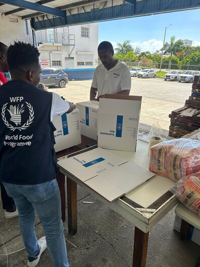 WFP staff preparing food parcels in to prepare the response to Hurricane Melissa.