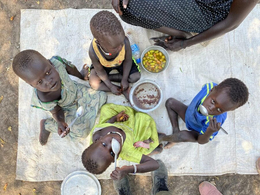 South Sudan: Children in Akobo East, Jonglei, take a lunch of sorghum with a local fruit — famine was last declared in the country in 2017. Photo: WFP/Marwa Awad