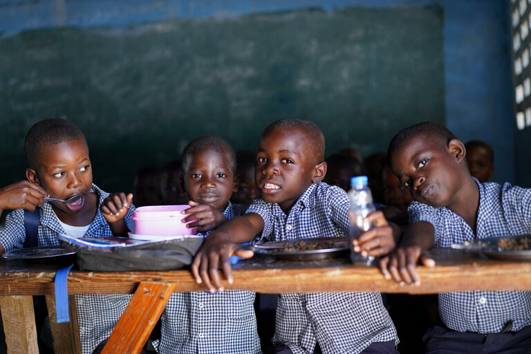 four kids are sitting in their classroom