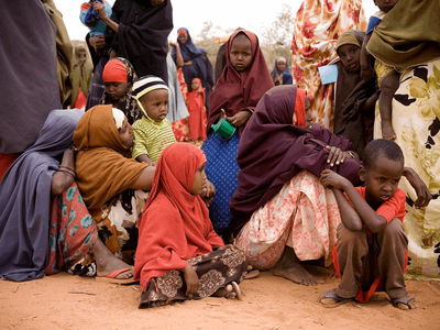 Women and children wait for assistance
