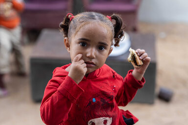 A girl in Gaza eating bread