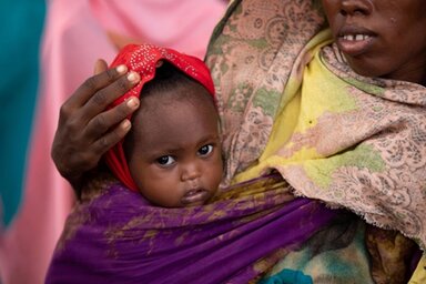 Somalia. Baby Mushtaq (15 months) is comforted by her mother Ayan (25) at the WFP funded Kabasa MAM Health Center