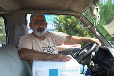 Zaher, 60, sitting in the car with a food parcel that he has just collected from WFP in Beirut. 