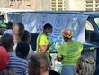Haitians line up for hot meals and water provided by WFP and a partner in capital Port-au-Prince. 