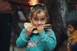 Hala, a five-year-old enjoying a freshly baked loaf of bread