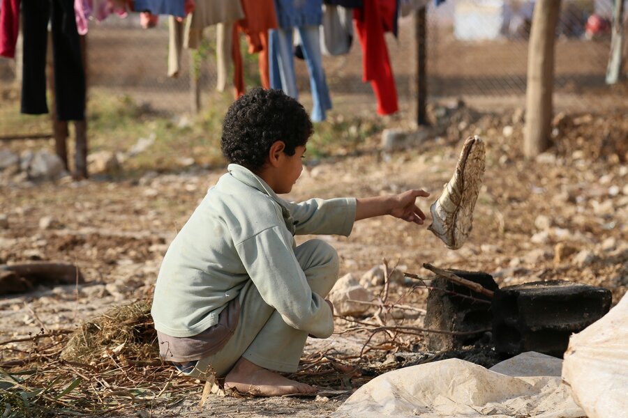 A displaced child in Adleih Town in Rural Damascus plays in front of a makeshift shelter in November 2014