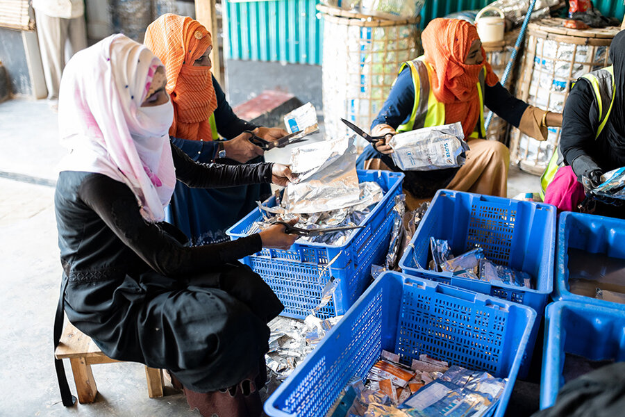 Women sort washed nutritional supplement packs at WFP's upcycling centre in Bangladesh's Cox's Bazar. Photo: WFP/Nihab Rahman