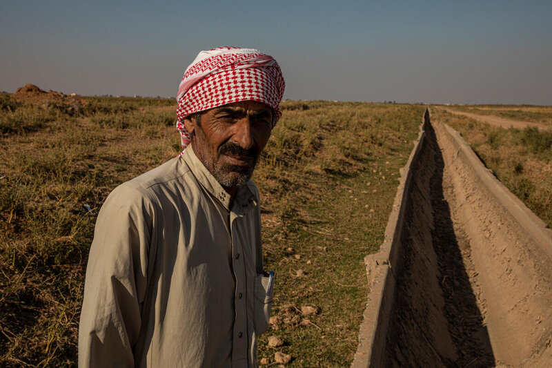 Khalifa standing next to an empty irrigation canal