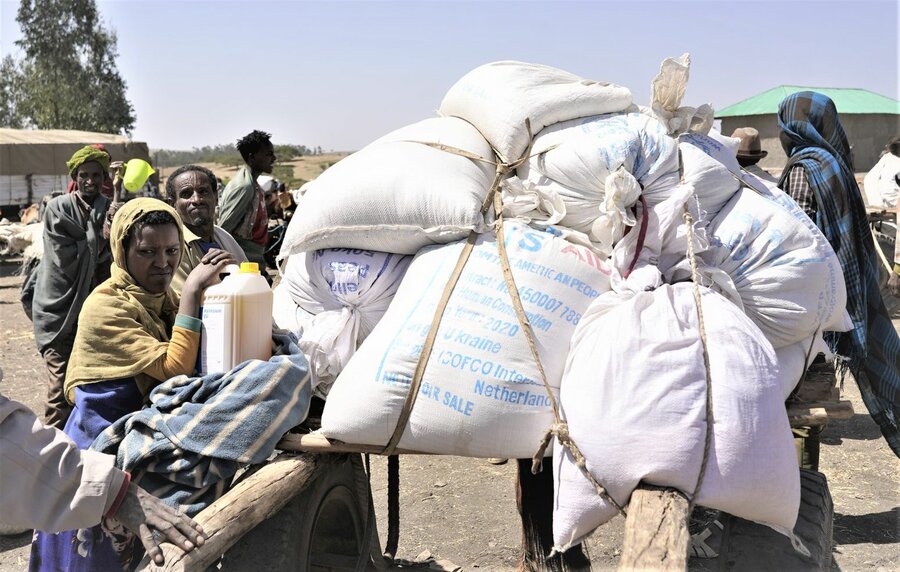 People in Dabat, Ethiopia, receive wheat sourced from Ukraine at a WFP distribution point in March. Photo: Claire Nevill