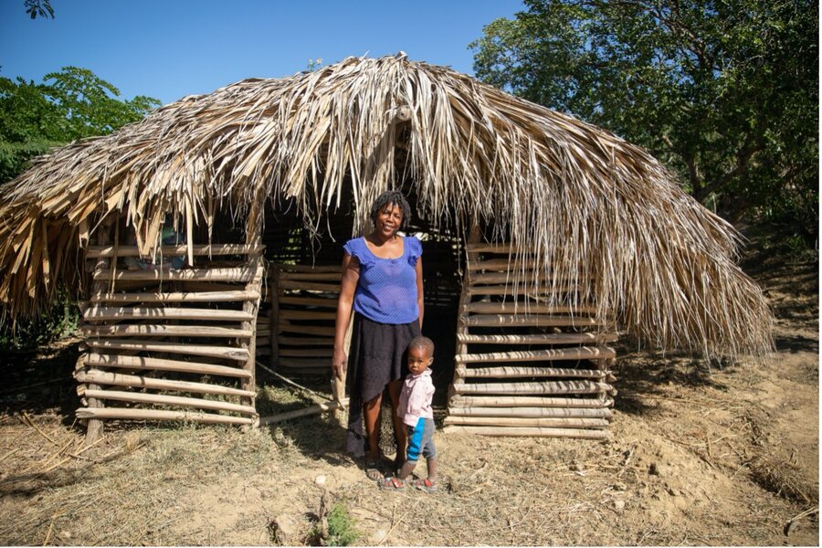 Edina Charles and her grandson Rubensley in front of their newly constructed goat shelter. Photo: WFP/Theresa Piorr
