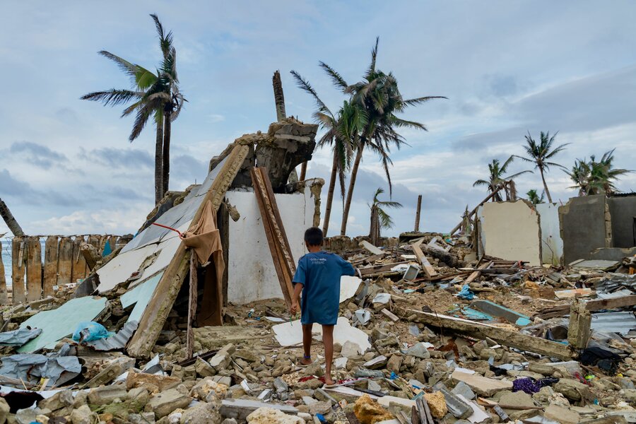 A boy picks his way through the destroyed town of Burgos, among the hardest hit by Typhoon Rai. WFP/Ivan Torres