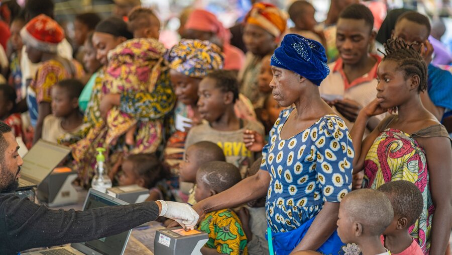 Women register to receive WFP cash assistance at a distribution site in eastern DRC. Violence has uprooted hundreds of thousands of people and deepened hunger. Photo: WFP/Michael Castofas