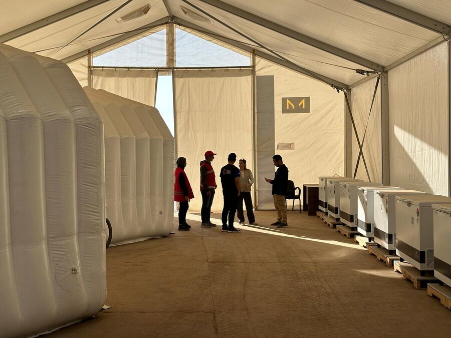 WFP staff inspect one of the warehouse units housing inflatable containers