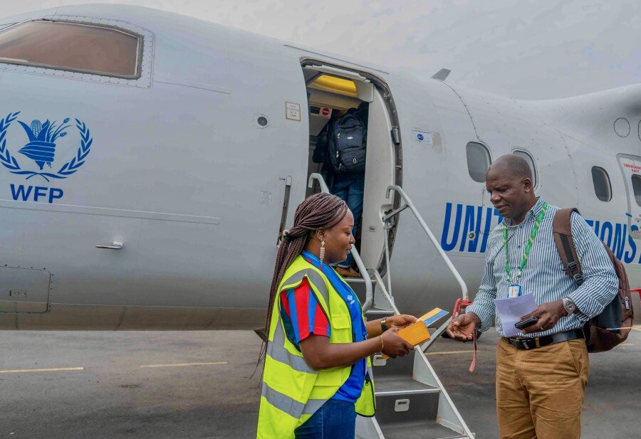 Humanitarian worker Kalongo Rwabikanga boards a UNHAS flight to Beni, in Democratic Republic of the Congo's restive northeast. Photo: WFP/Benjamin Anguandia