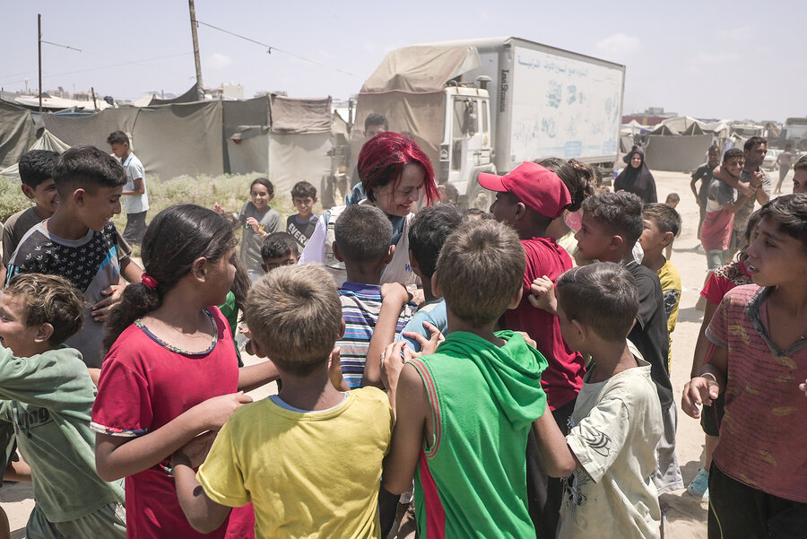 Regional Director Corinne Fleischer surrounded by children while on mission in Syria