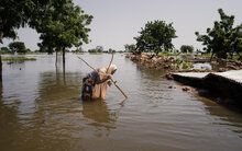 Azimi Abubakar, 50, a resident of Gasamu, wades through the floodwater in Jakusko LGA of Yobe State, Nigeria, on 01 October 2022. ©WFP