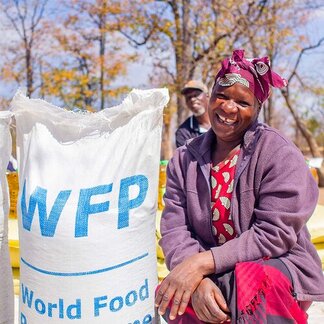 oman receives food assistance at the WFP food distribution site in Mwenezi. 