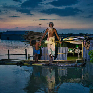 An old man and a child living in a flooded area. Photo: WFP/Sayed Asif Mahmud